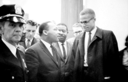 Les militants des droits civiques Martin Luther King (g) et Malcolm X, avant une conférence de presse dans un lieu non connu, le 26 mars 1964