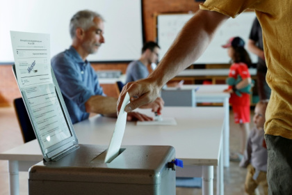 Un électeur vote sur une proposition de loi anti-immigration visant à plafonner la population du pays et sur un projet gouvernemental pour resserrer les critères d'accès au service civil, le 14 juin 2026 à Berne, en Suisse - STEFAN WERMUTH (AFP)